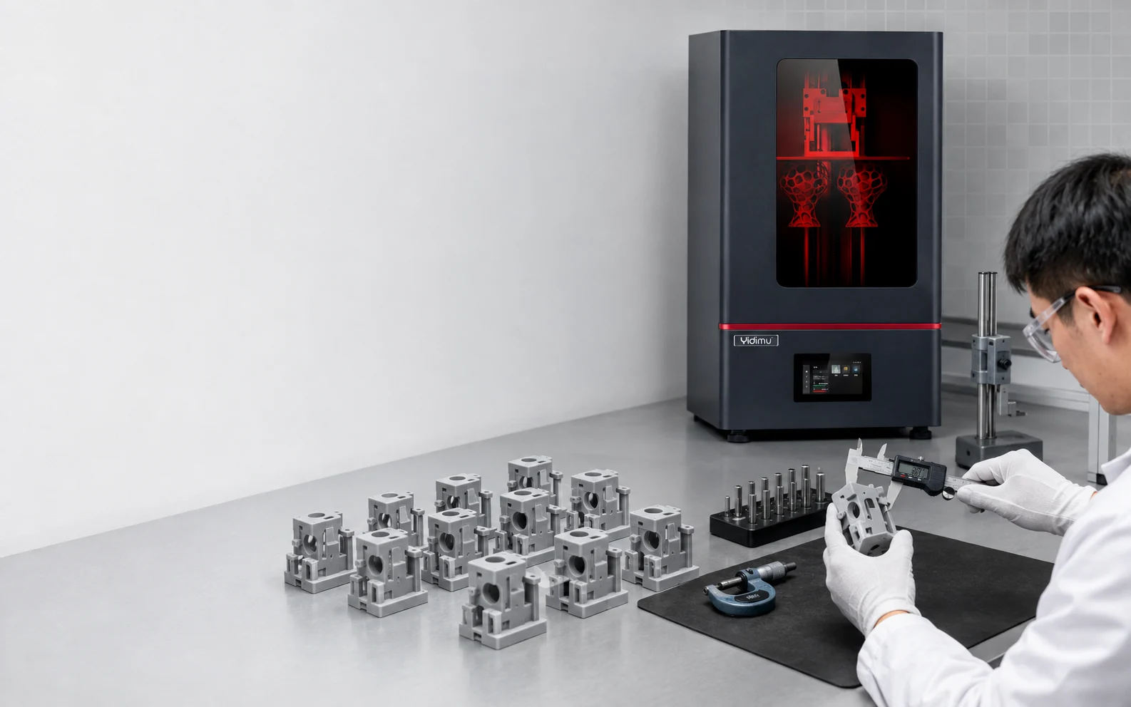 Engineer comparing pixel size with measured print accuracy on finished resin 3D printed parts